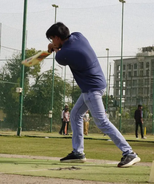 Clean straight drive during cricket match
