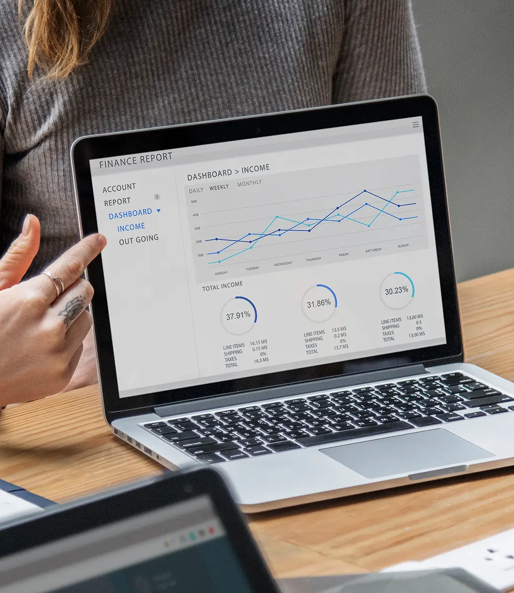 Professionals in an office analyzing financial graphs and data together, representing business planning and Odoo ERP analytics.