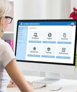 HR using human resources software on a computer, illustrating full-cycle HR management including recruitment, payroll, and employee records within an all-in-one IT management system.