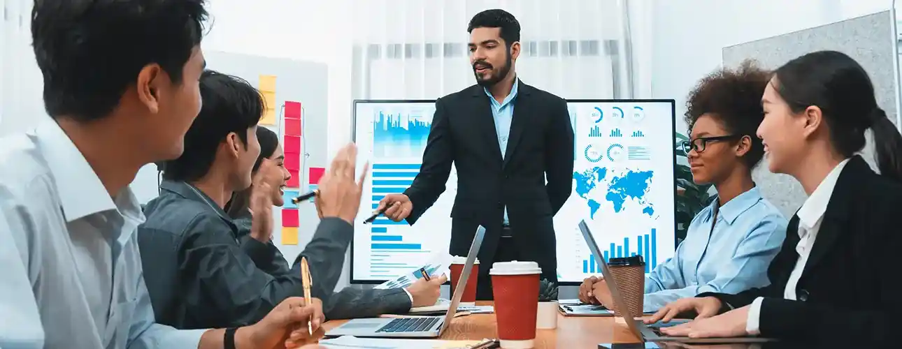 Business team collaborating and sharing ideas during a presentation – symbolizing teamwork and innovation at Softhealer Technologies