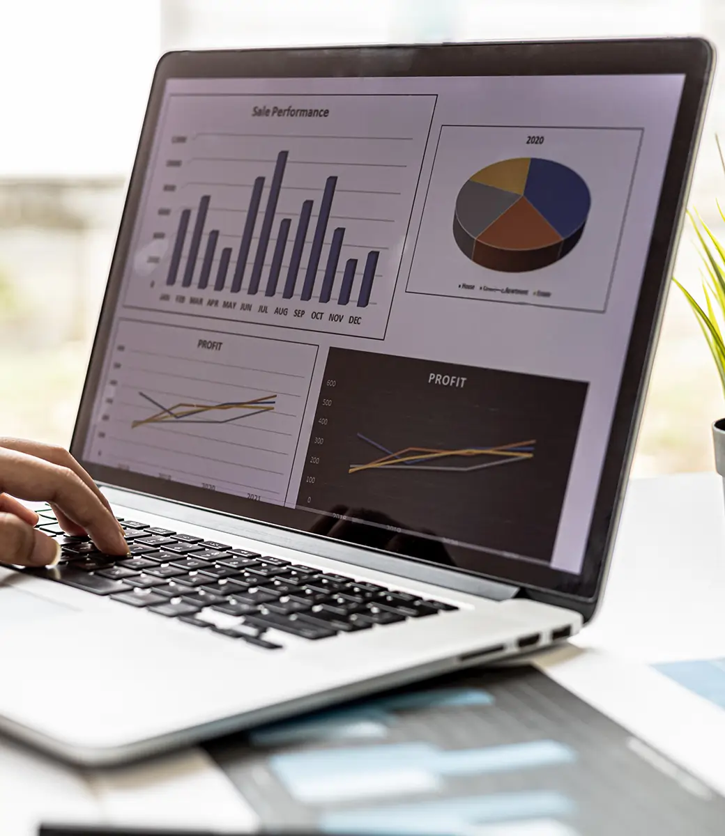 Laptop screen displaying Odoo ERP dashboard with modules for Sales, Inventory, Invoicing, CRM, Purchases, Apps, Discuss, and Reporting