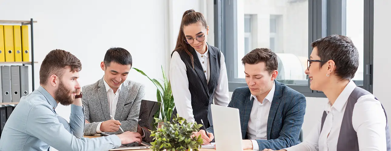  Group of young business professionals discussing a strategy in a modern office representing teamwork, IT collaboration, and business planning for ERP implementation